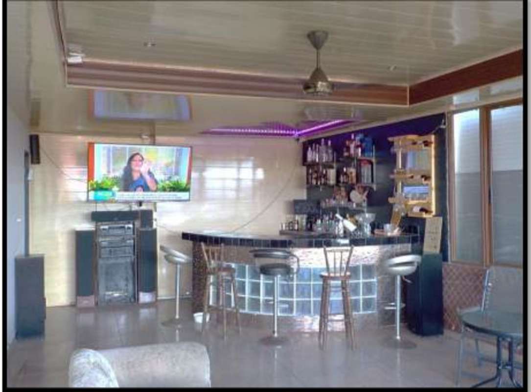 Home bar with glass blocks wall-mounted TV and lights Altos de La Castellana Panama