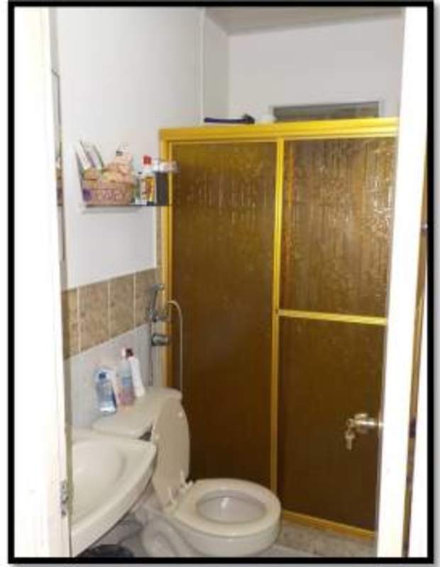 Bathroom featuring glass shower enclosure, toilet and sink at house in Altos de La Castellana