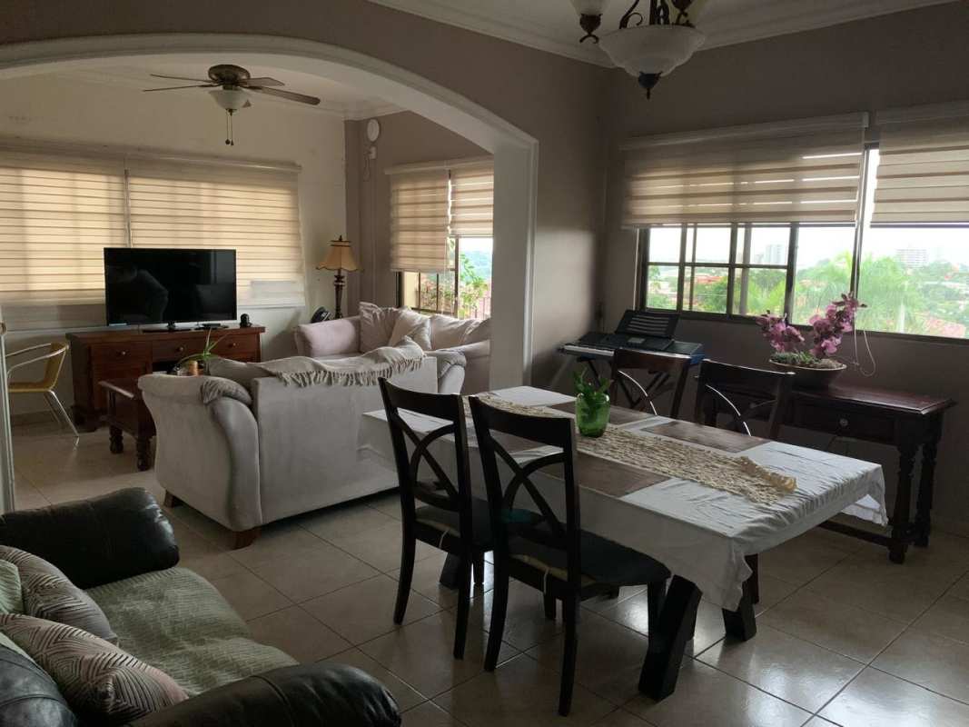 Open plan living and dining area with natural light and neutral colors in Altos de Bethania house Panama City
