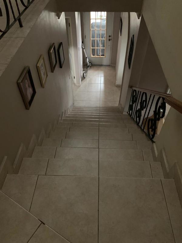 Living room space with large sliding glass doors opening to balcony and city views at Altos de Bethania Panama