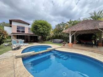 Bedroom with ensuite bathroom and garden view in Villas Decameron beach house for sale Panama