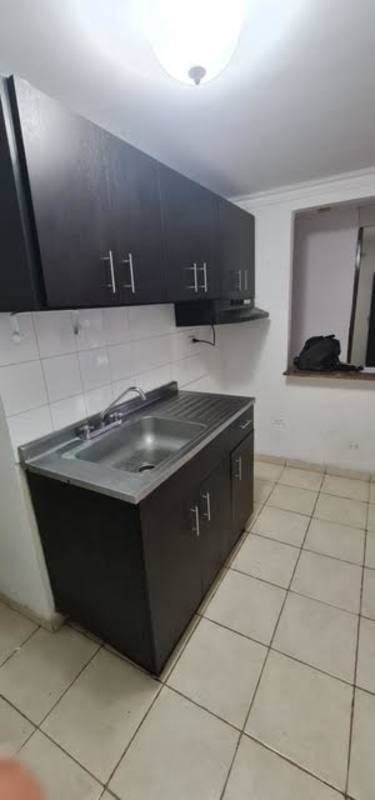 Small modern kitchen with dark cabinets tile backsplash and granite counter in Río Abajo Panama