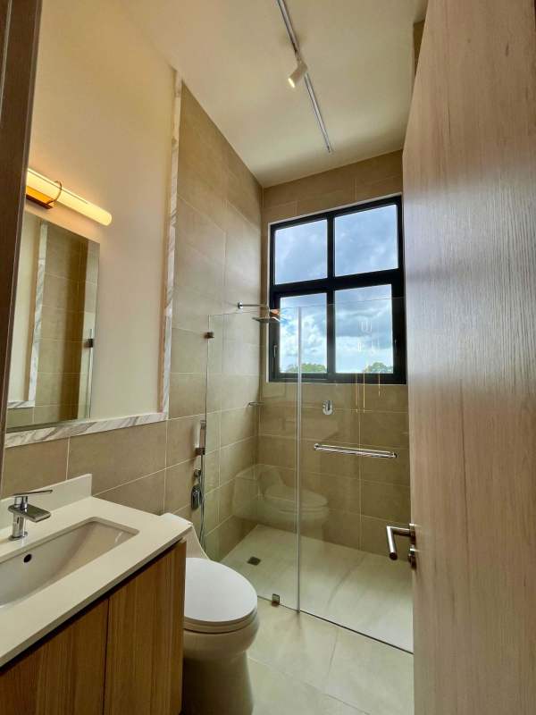 Stylish bathroom with walk-in glass-enclosed shower and window Ocean House Santa Maria Panama