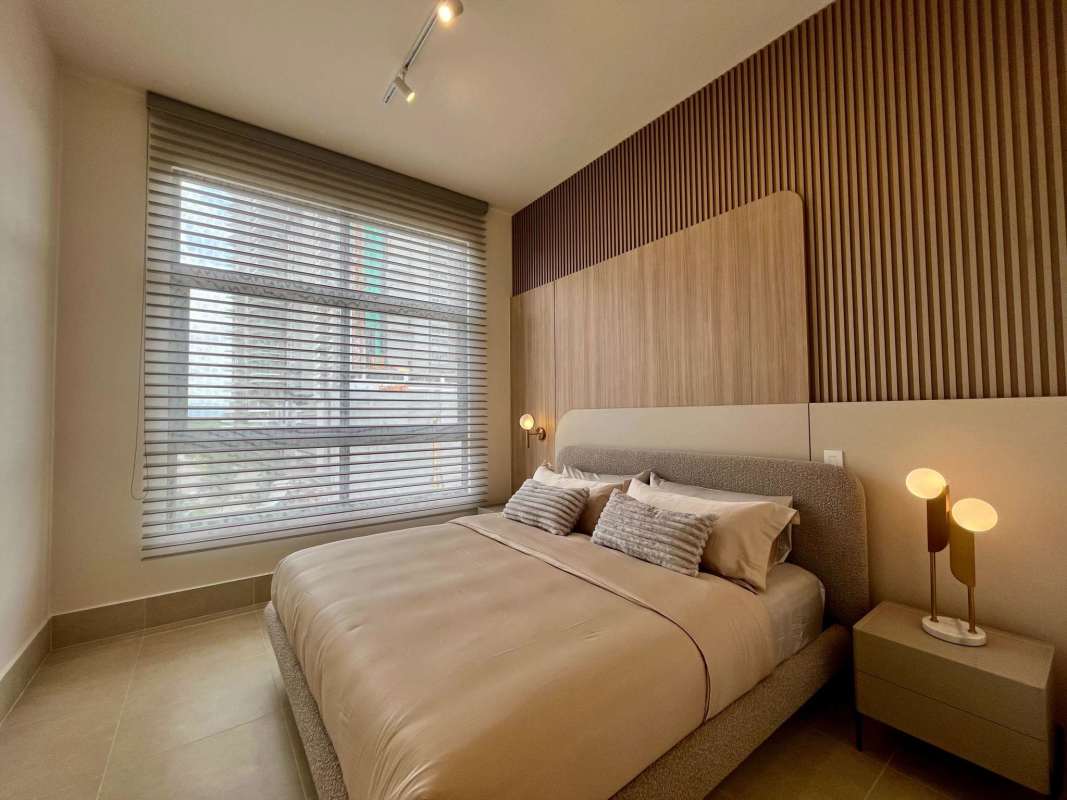 Modern comfortable bedroom with accent wall and city views Ocean House Santa Maria Panama