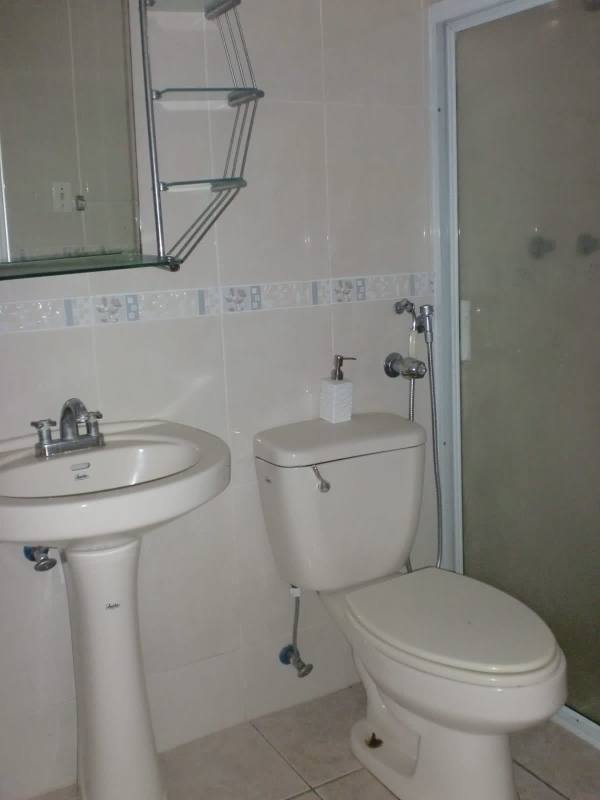 Bathroom with pedestal sink, glass shower enclosure, decorative tile Panama City