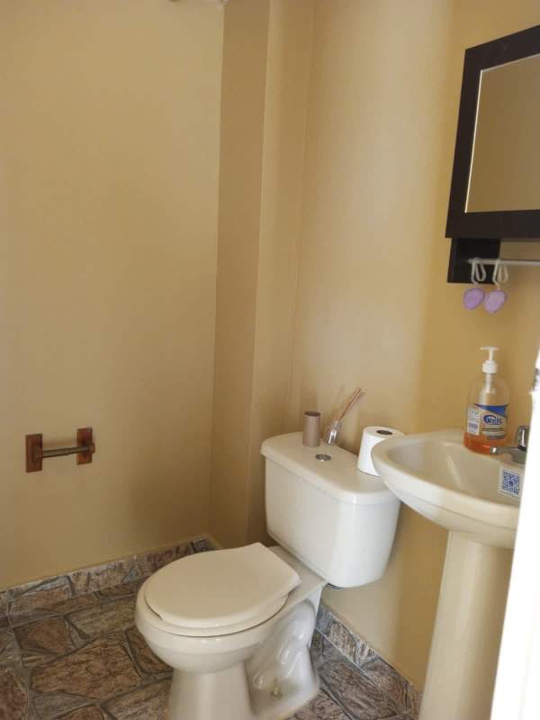 Functional kitchen with granite countertop, gas stove and orange dining chairs Brisas del Golf Panama