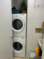 Compact laundry with stacked washer dryer and utility sink at Puntarenas Buenaventura