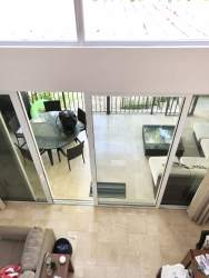 Double-height living room with glass doors to terrace in Puntarenas Loft Buenaventura Panama