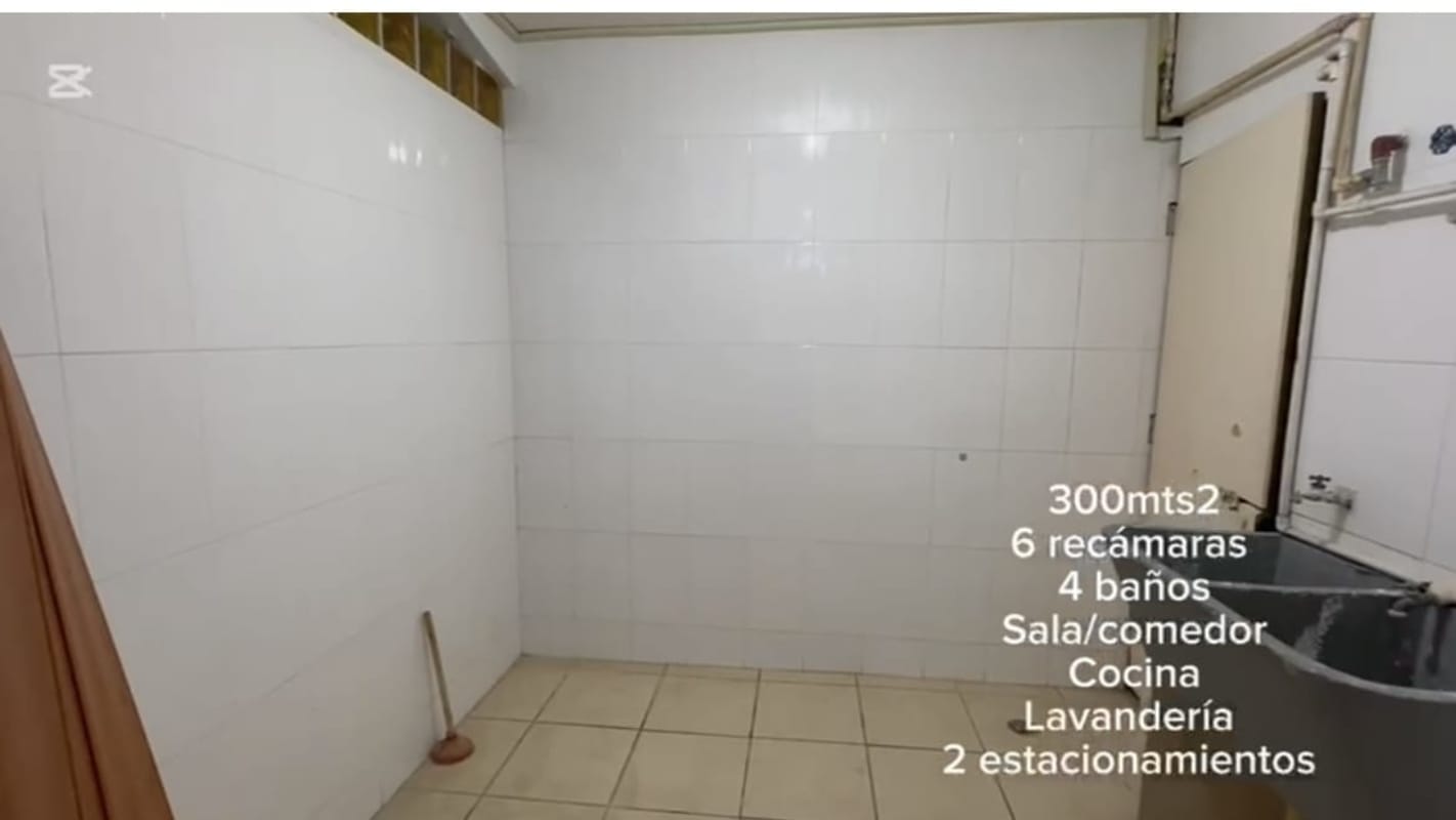 Laundry room with tile walls, utility sink and window at Brisas del Golf house Panama rental