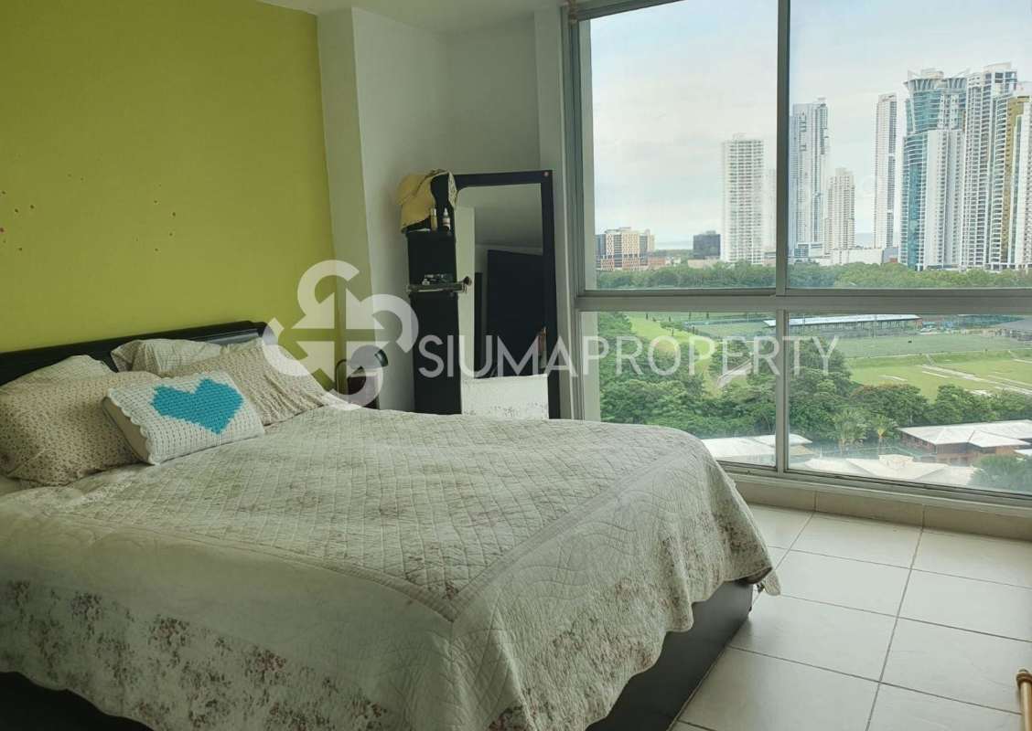 Bedroom with large window overlooking Panama City skyline in PH Costa View Tower Costa del Este