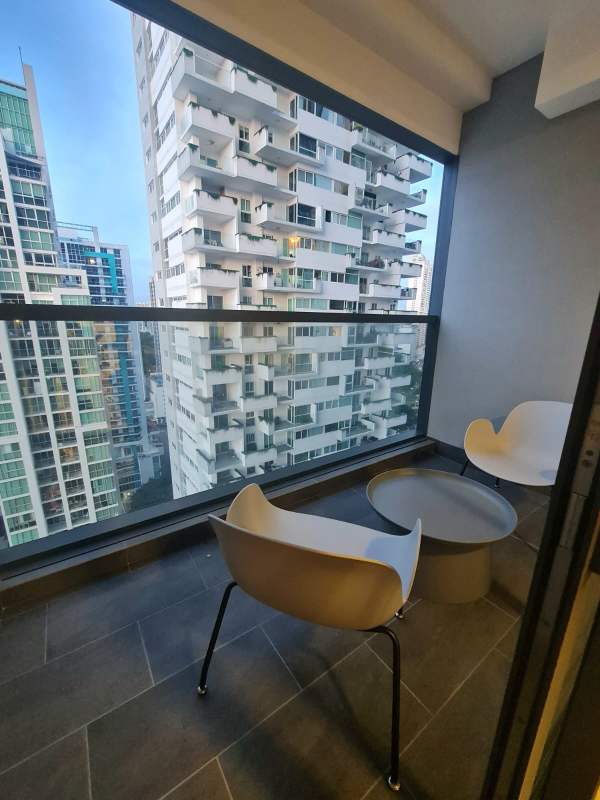 Private balcony with glass rail showcasing skyline view at PH Nuovo by Artmani