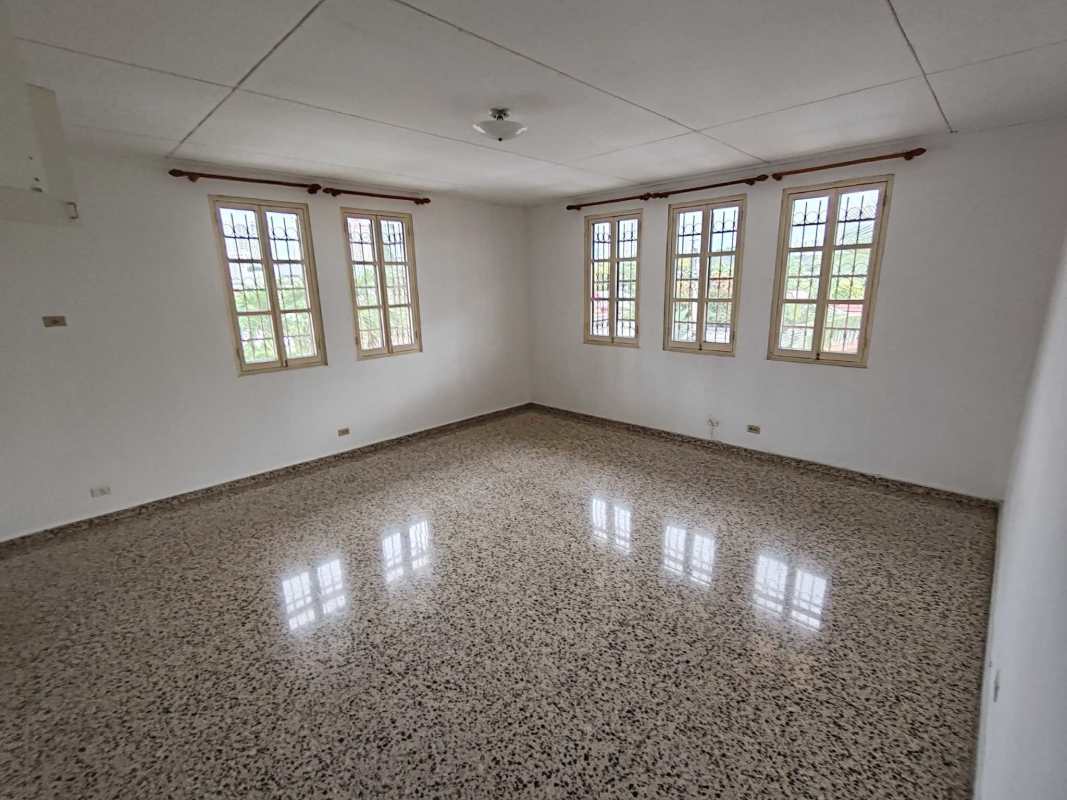 Spacious living room with multiple windows terrazzo floors in Panama rental home