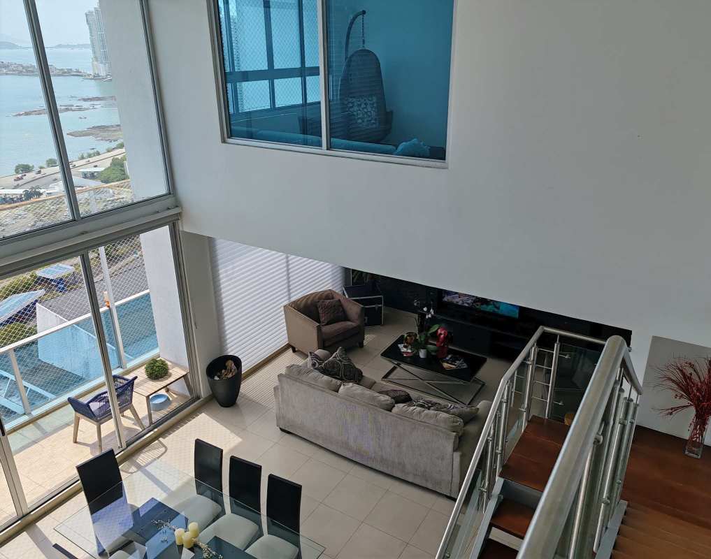 Spacious loft-style living with glass staircase ocean view duplex apartment PH CaboMarzo for rent Panama