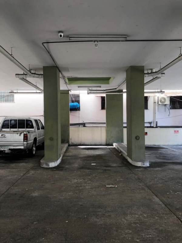 Covered parking garage with dedicated spaces inside PH Parque Lefevre building Panama