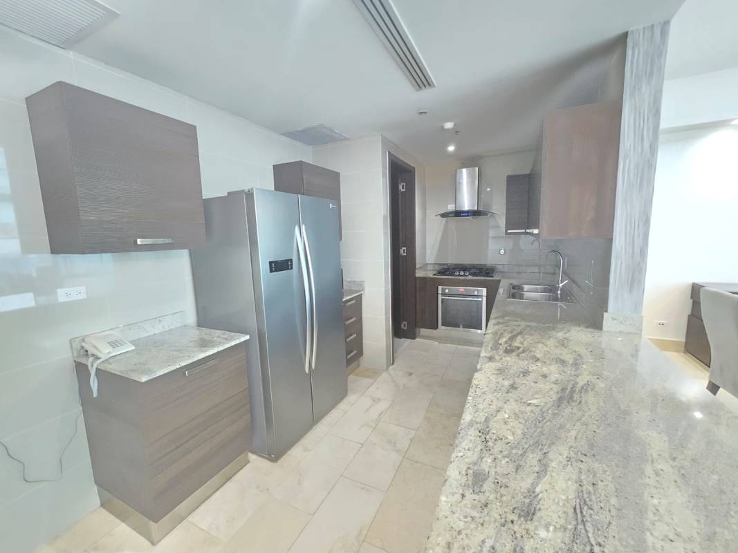 Open kitchen with granite countertops stainless appliances marble flooring Grand Tower Punta Pacífica apartment
