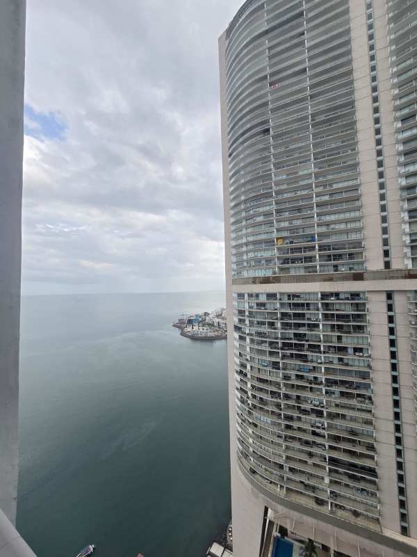 Modern high-rise Grand Tower with balconies overlooking Pacific Ocean Punta Pacífica skyline Panama City