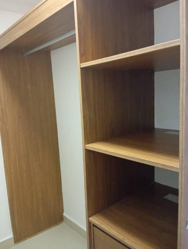 Contemporary kitchen with granite counters, wood cabinets, and stainless appliances at PH Worldwide Plaza