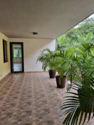 Covered terrace balcony with tiled floors and garden views at PH River Valley Panama Pacifico
