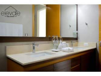 Bedroom with balcony access, large glass door, ocean and golf views at Casamar beach apartment Panama