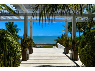 Covered pergola walkway with lush gardens ocean view Casamar beach community Panama