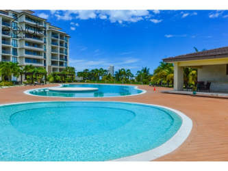 Resort style pool with lounge area in Casamar beachfront condos Panama