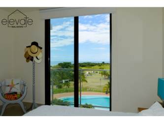 Open-concept living dining room with tile floors, neutral walls in Casamar golf resort Panama