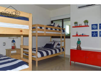 Modern bathroom with double sink vanity and large mirror in Casamar oceanfront apartment Panama