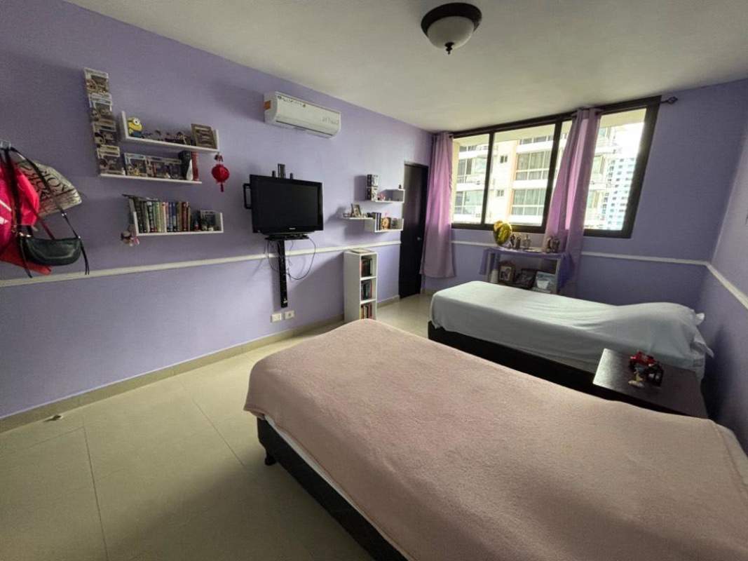 Secondary bedroom with windows to ocean and city skyline at PH Yacht Club Tower Panama