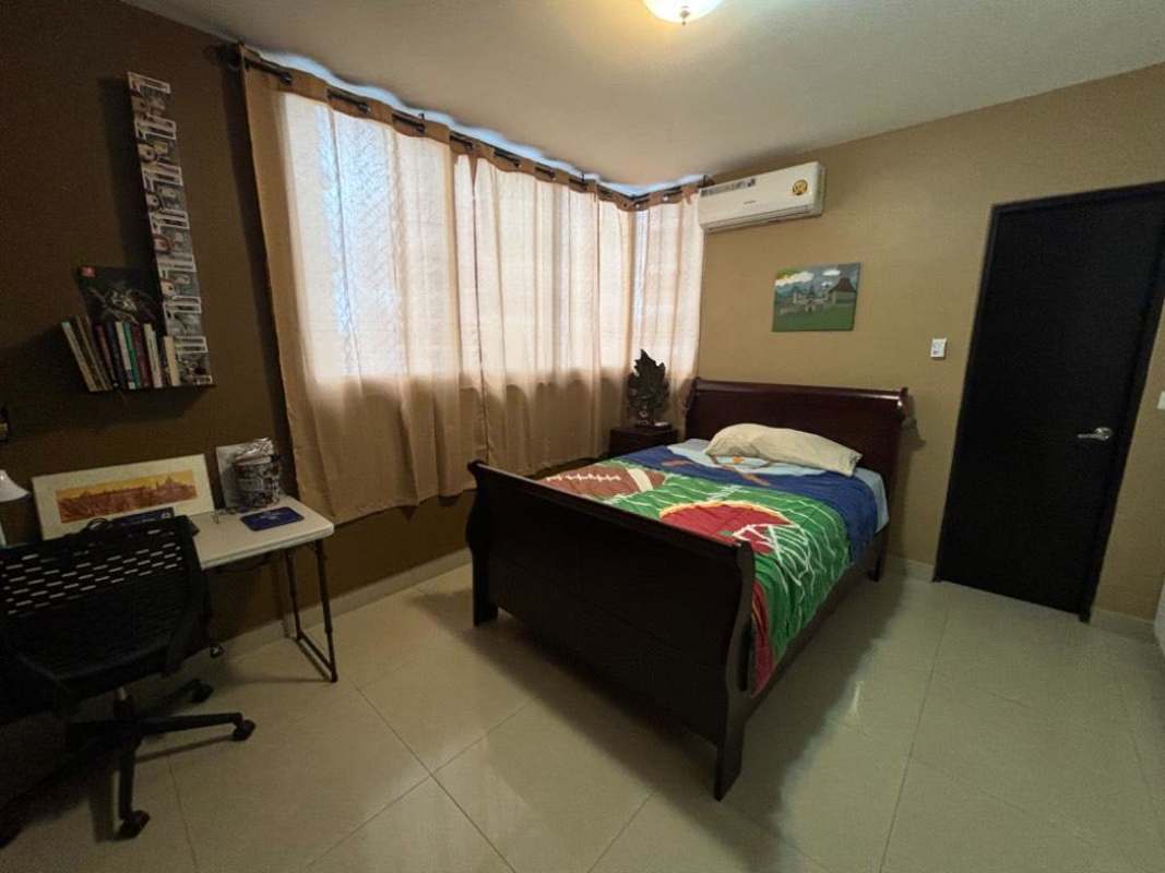 Furnished master bedroom with oceanfront window, king size bed, TV at PH Yacht Club Avenida Balboa Panama City