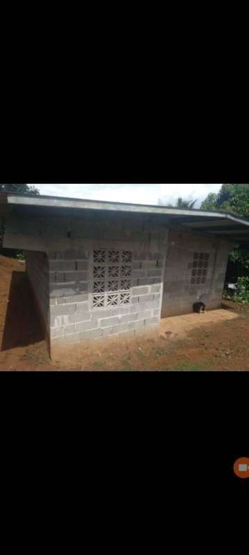 Simple concrete block exterior unfinished small house with metal roof Chepo Panama