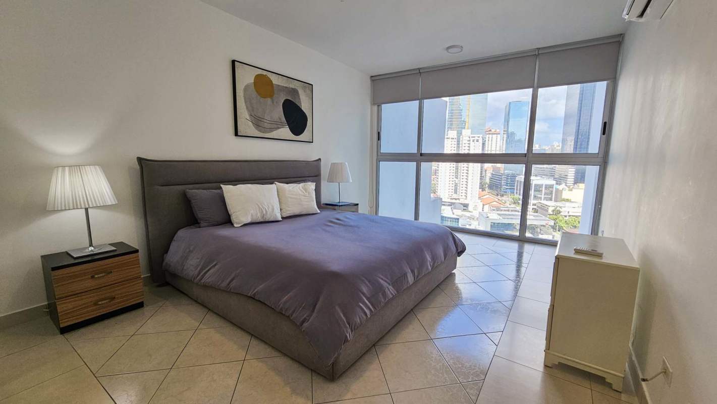 Master bedroom with ocean view windows and queen bed in PH Waters On The Bay Panama