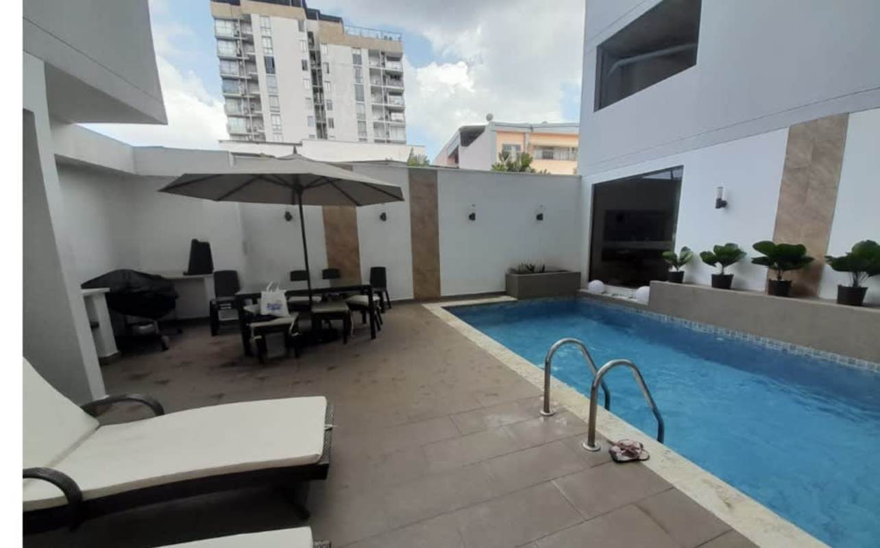 Outdoor pool with lounge chairs, dining, BBQ patio PH Liberty Tower Panama City