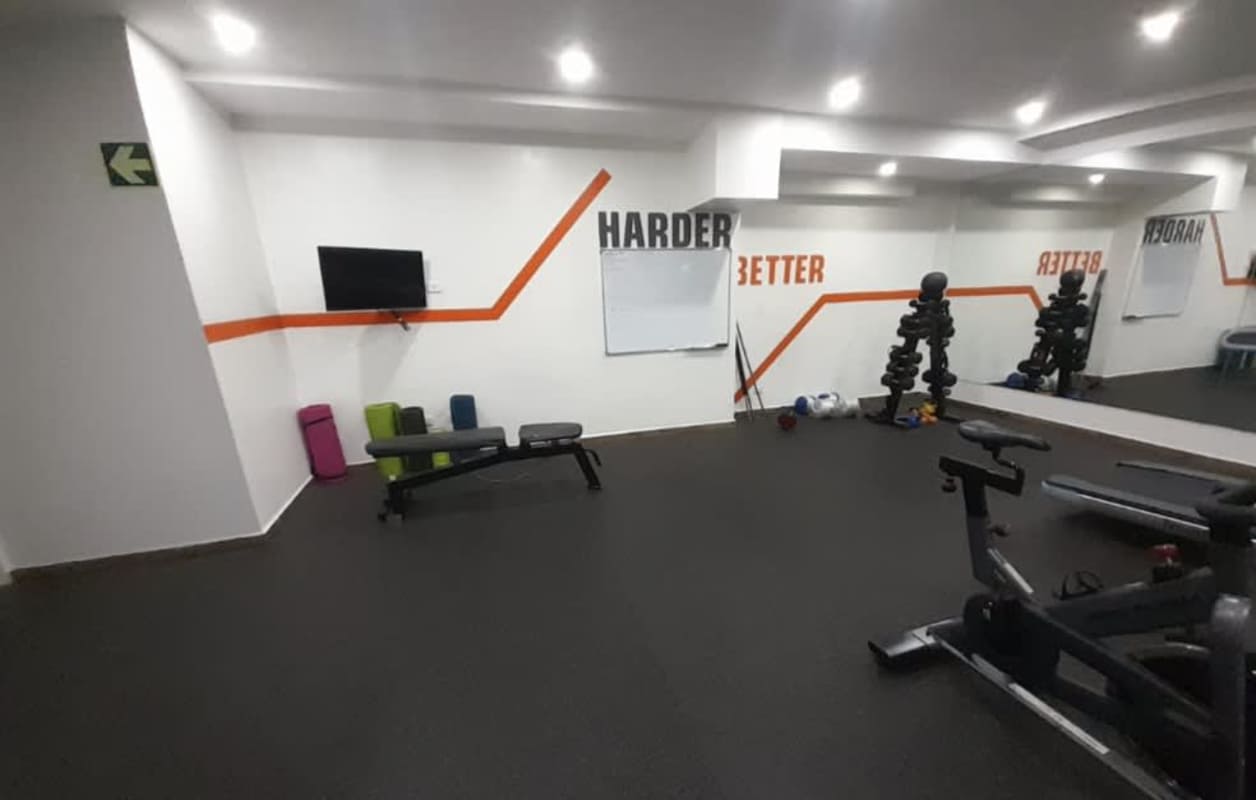 Well-equipped modern indoor gym with weights, spin bikes at PH Liberty Tower Panama City