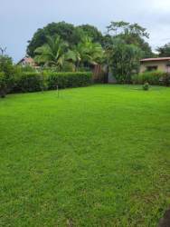 Yellow kitchen with breakfast area and white cabinets in Palmas de Gorgona house Panama