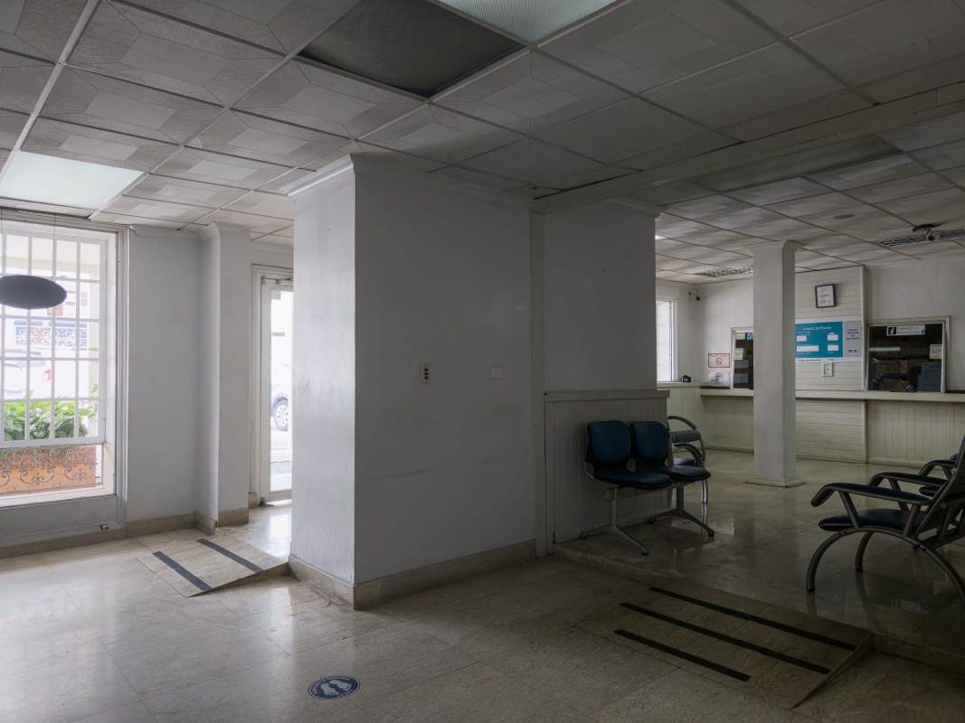 Consultation space with desk and shelves inside hospital building Panama City