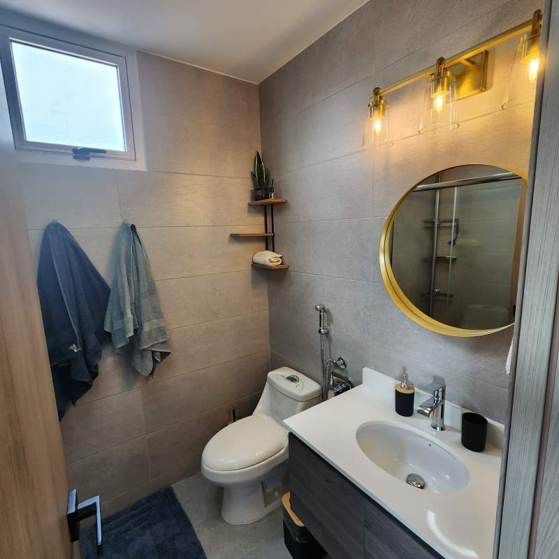 Modern bathroom with glass enclosure and vanity PH Park Square Panama rental