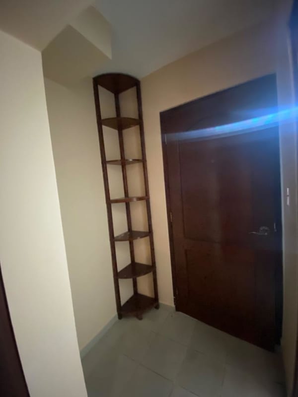 Entryway with corner wooden shelf and wooden door PH Valencia Bethania Panama