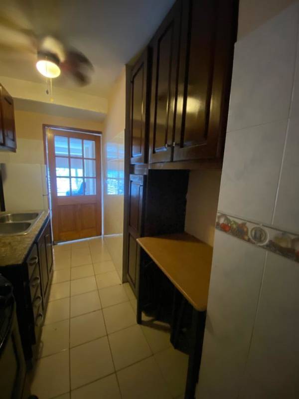 Kitchen with wooden cabinets, granite countertop, tile backsplash, gas stove in PH Valencia Bethania Panama