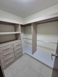 Spacious walk-in closet storage shelves drawers apartment Panama Pacifico PH Mosaic