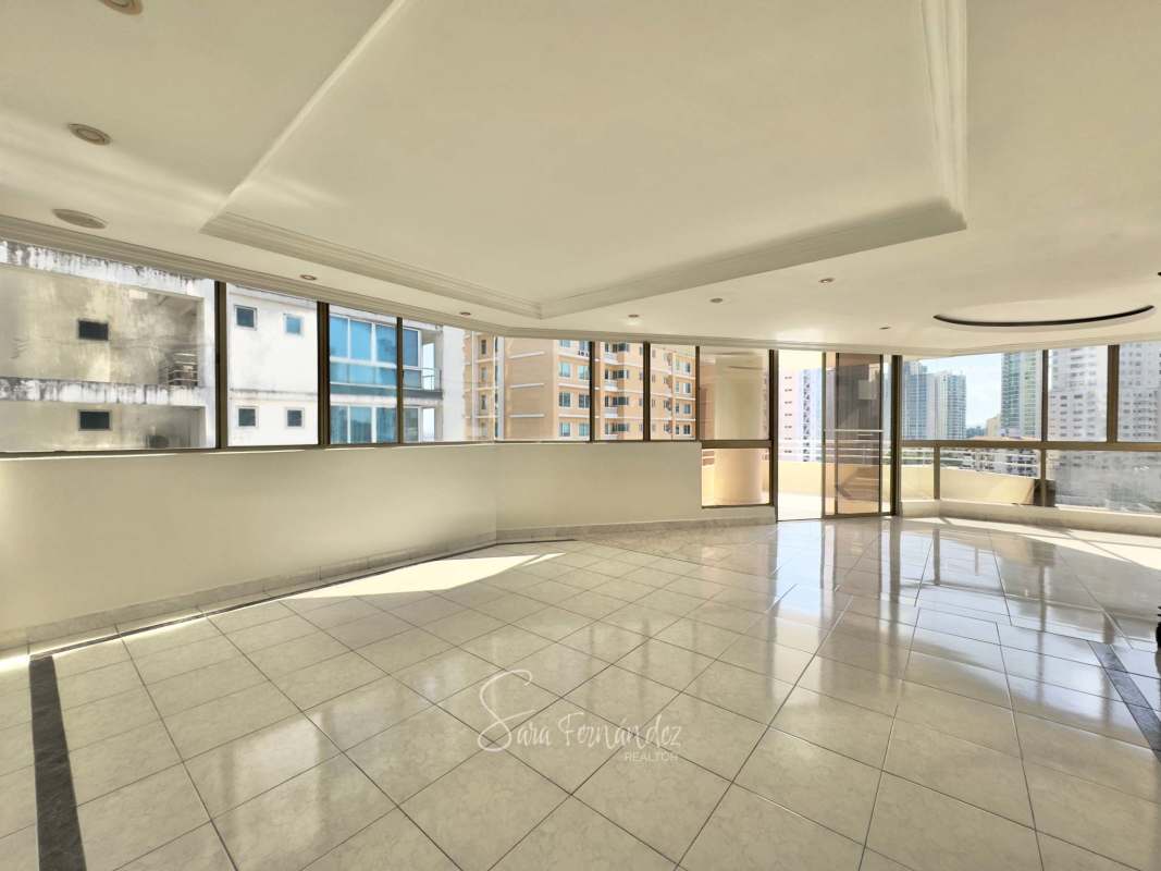 Modern large living-dining area with panoramic windows and ceramic floors in PH Avenida Balboa Panama City