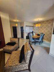 Spacious contemporary living room with large windows and accent wall in Panama Pacifico duplex house