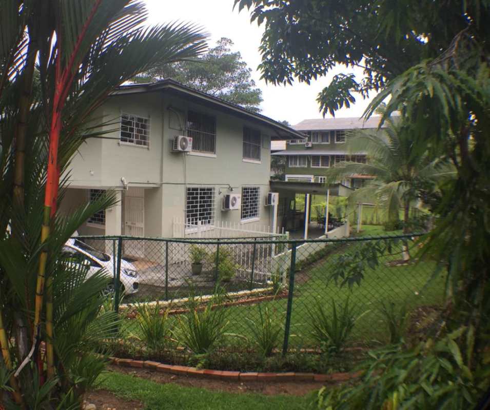 Front view of two-story house with garden and parking Diablo Heights Panama