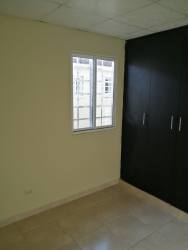 Minimalist bedroom with window, built-in wardrobe, ceramic tile Playa Leona rental home