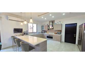 Spacious master bedroom with AC, large windows overlooking garden in Panama Pacifico home