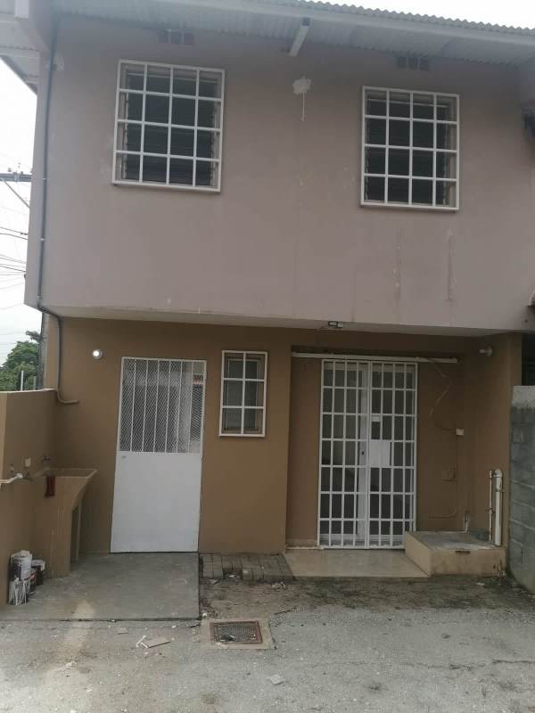 Beige two-story duplex house with barred windows Tocumen Panama