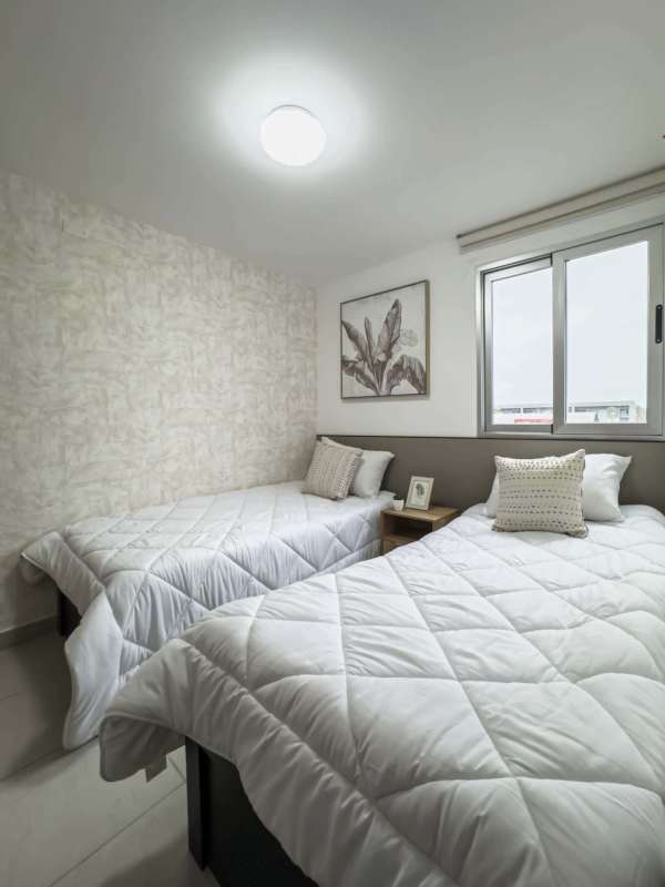 Bright modern living and dining open area with large window PH Los Pueblos Tower Panama City