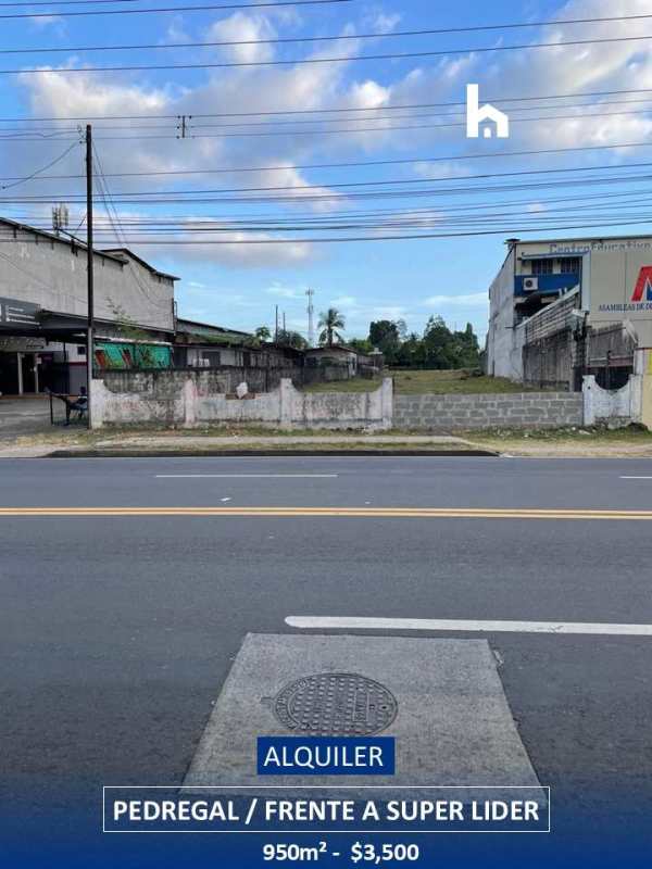 Vacant commercial land bordered by masonry and wire fence facing traffic Pedregal Panama City