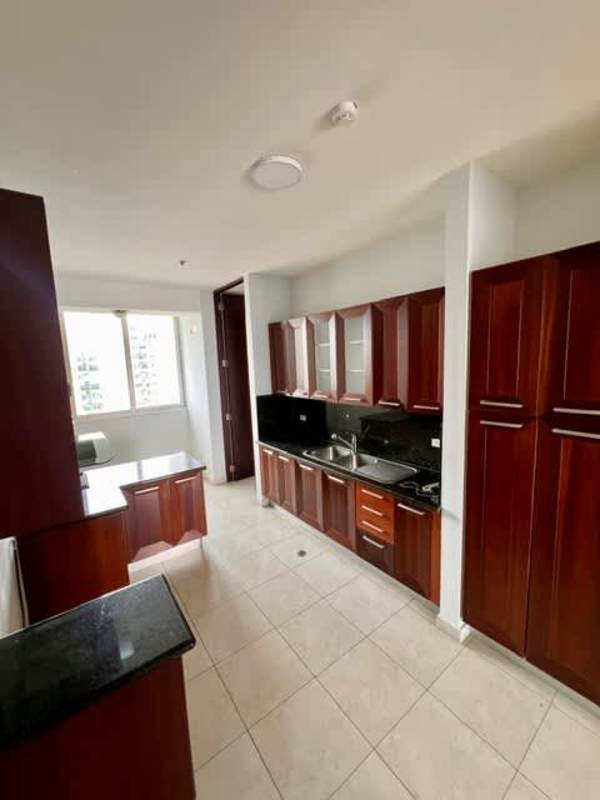 Contemporary kitchen with dark wood cabinets, black granite countertops and large window PH Aqualina Panama