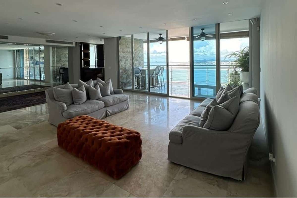 Modern living room with sofa and panoramic ocean skyline at PH Ocean Reef Punta Pacifica Panama