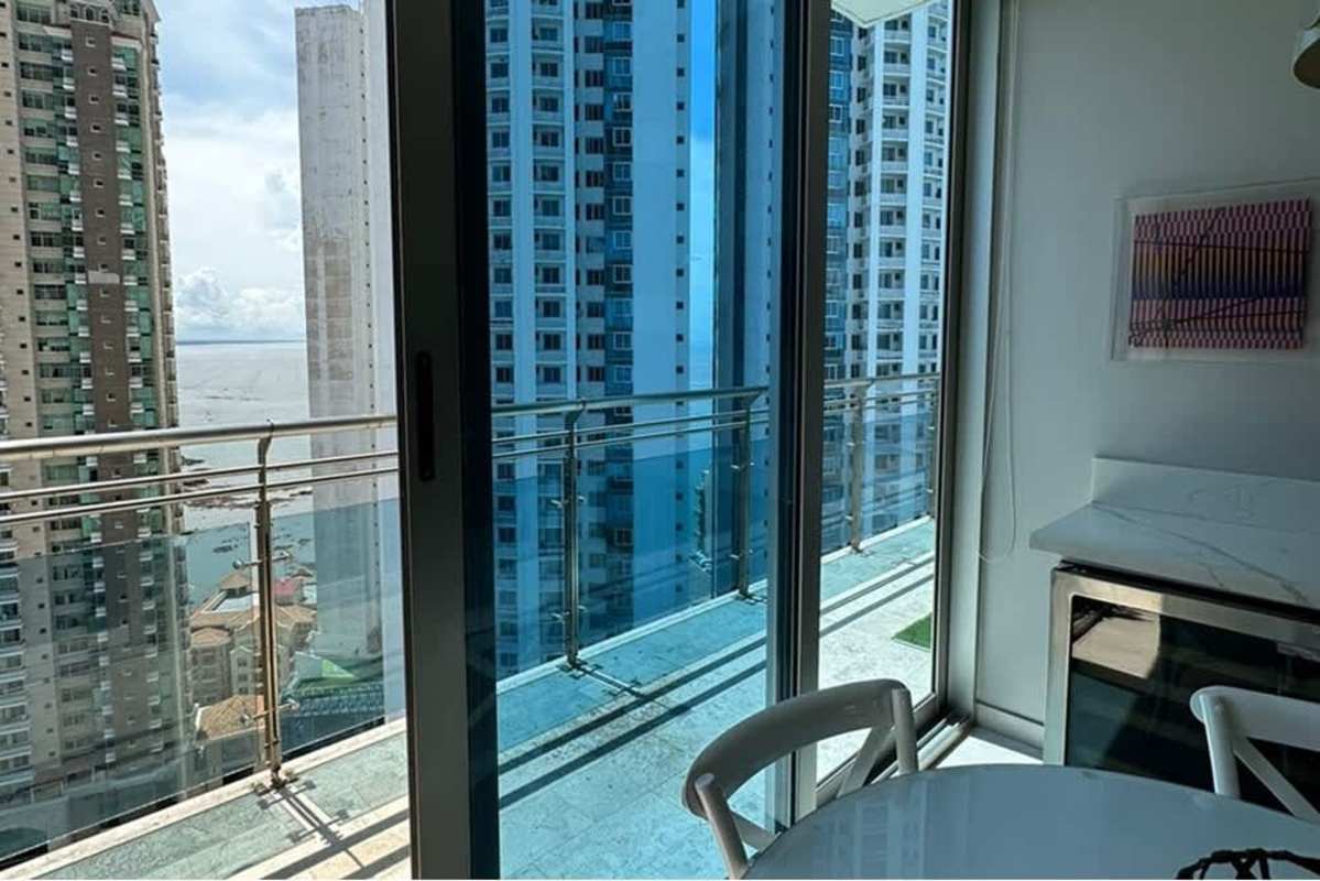Dining area with glass doors to balcony city skyline oceanfront view Punta Pacifica Panama